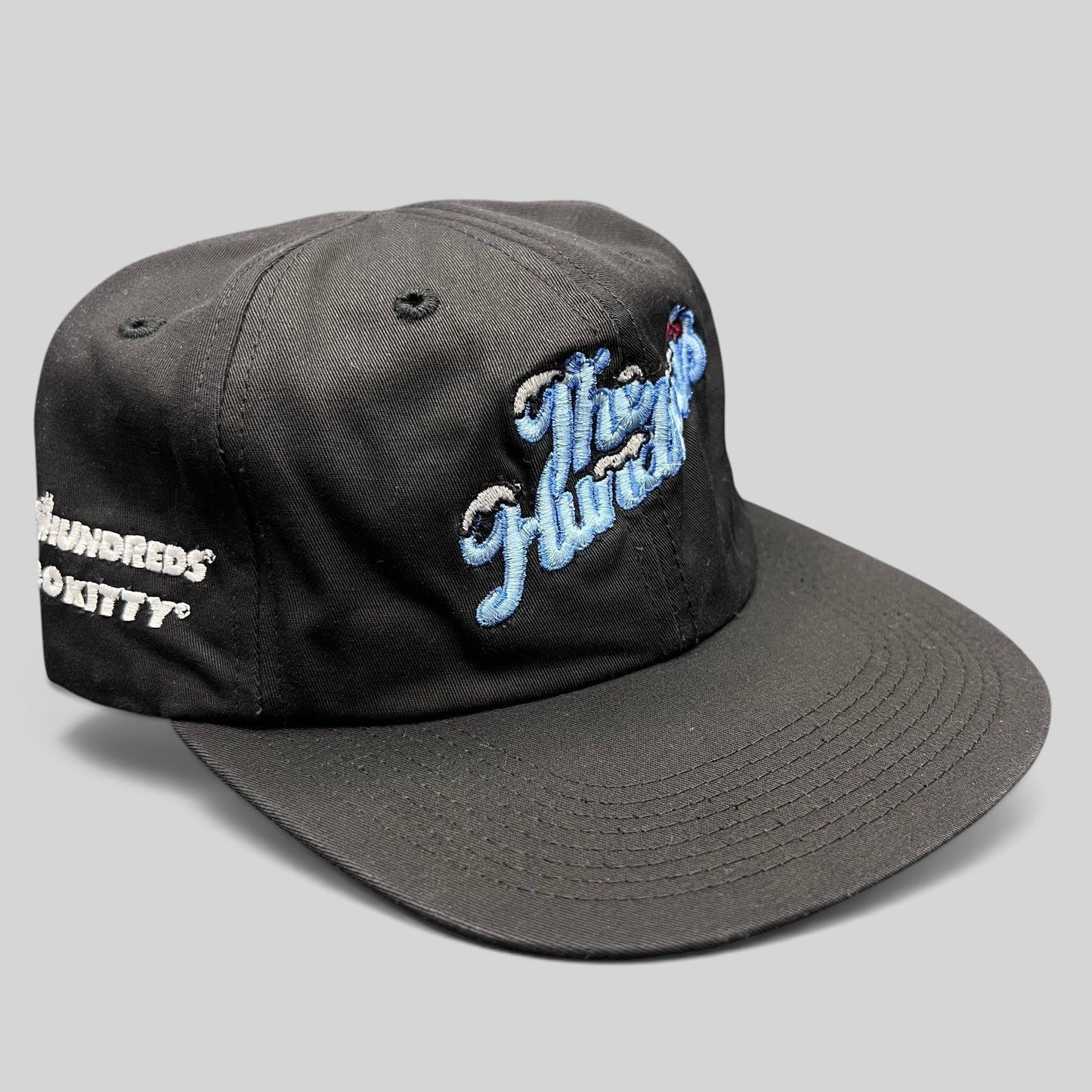 Raree Finds The Hundreds x Hello Kitty black cotton snapback hat with blue embroidered script and curved brim