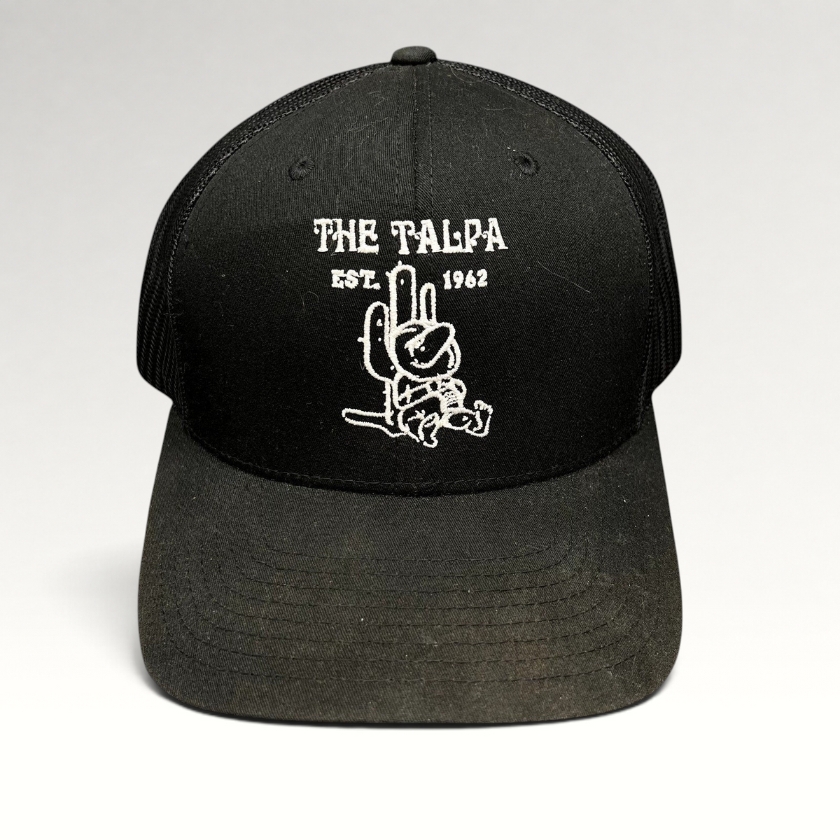 Raree Finds black Yupoong trucker snapback hat featuring The Talpa Est. 1962 embroidered cactus mascot logo.