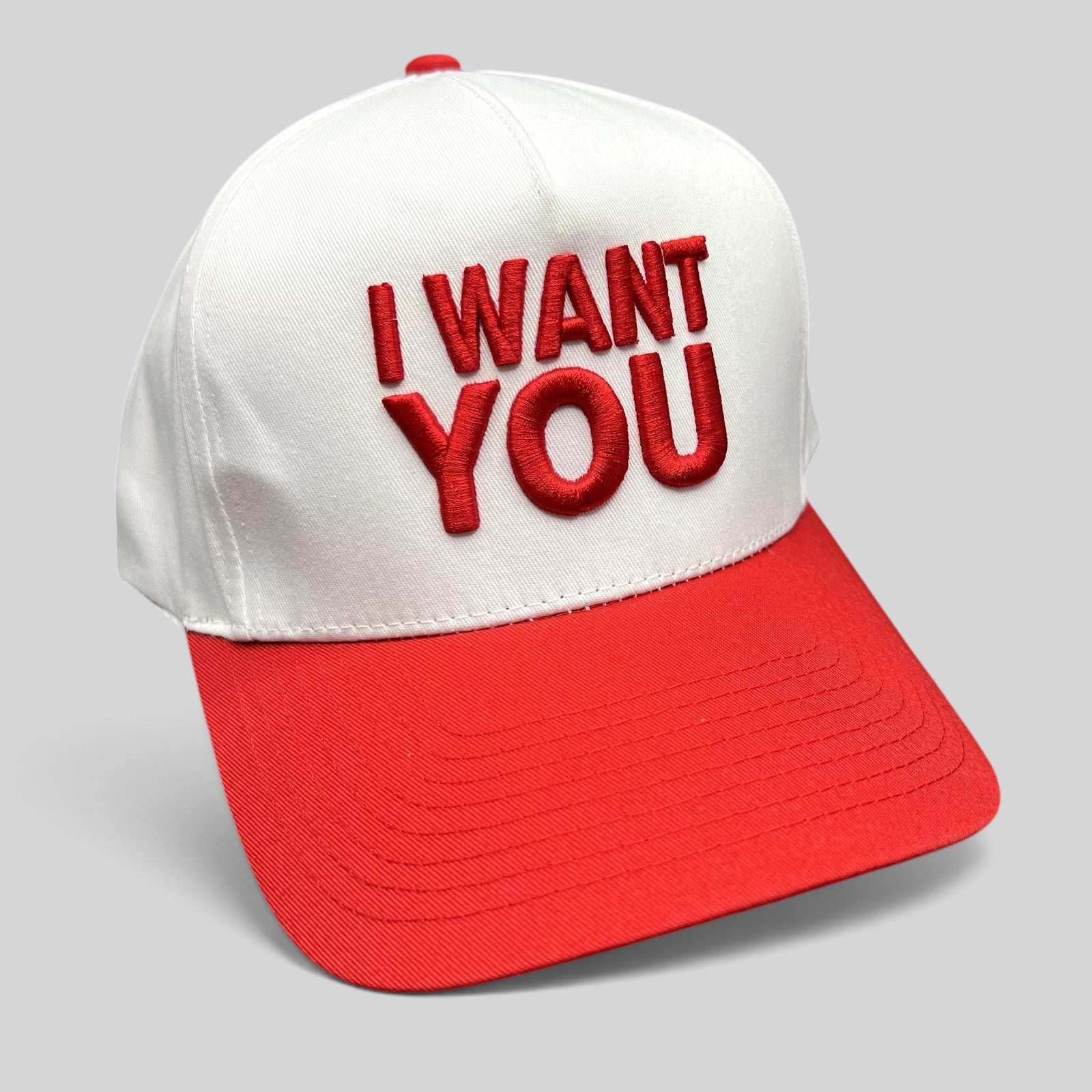 Raree Finds The Voice I Want You snapback hat with white crown, red brim, and bold red raised embroidery.