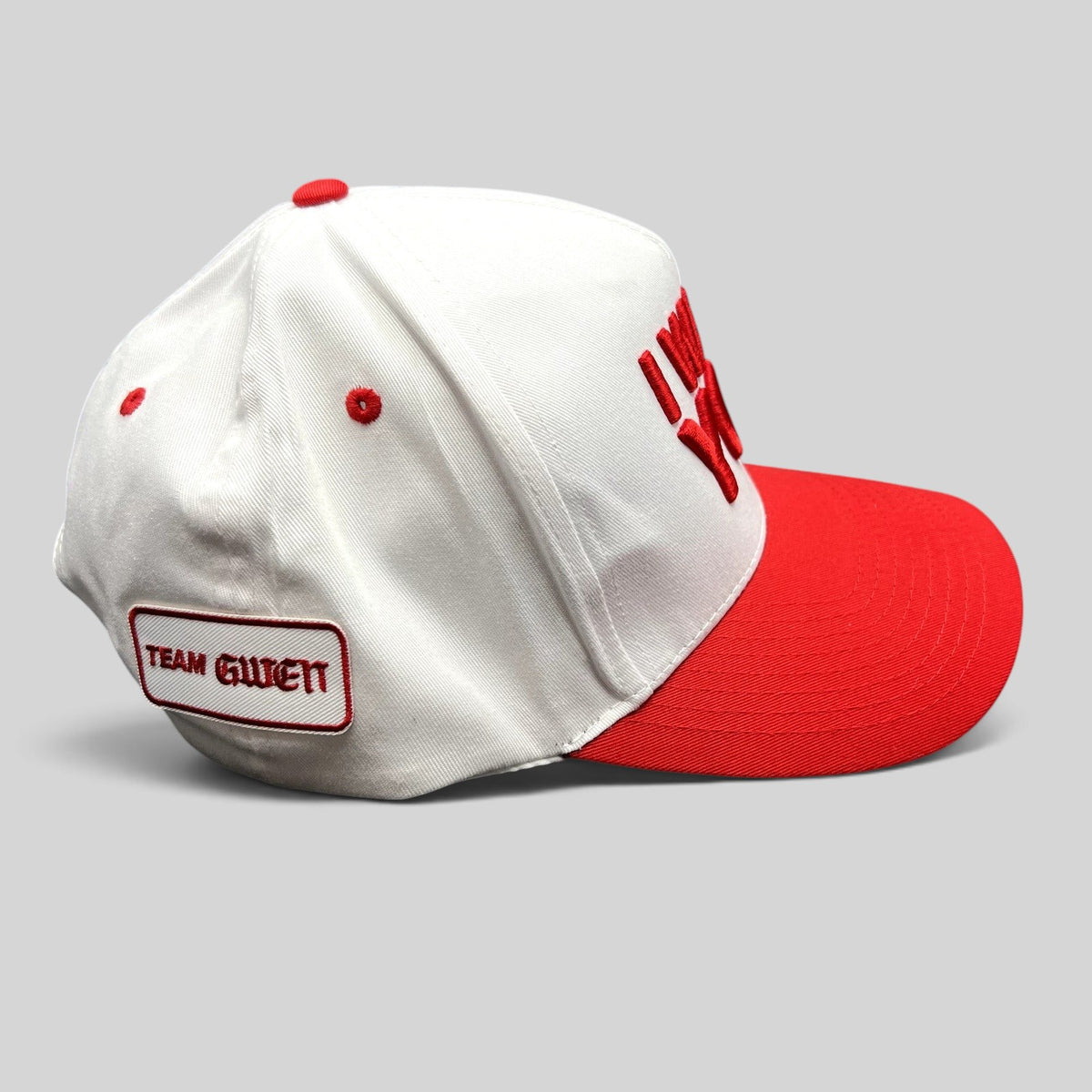 Raree Finds The Voice snapback hat with white crown, red brim, and Team Gwen embroidered patch on the side.