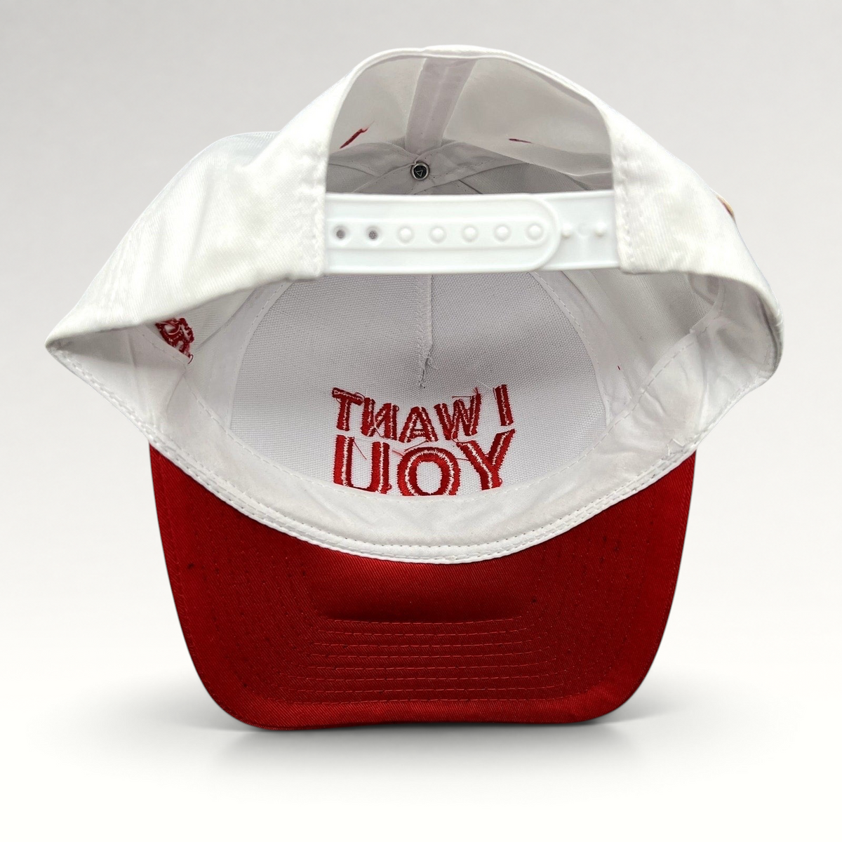 Raree Finds The Voice snapback hat interior view showing red I WANT YOU embroidery on a white crown and red brim
