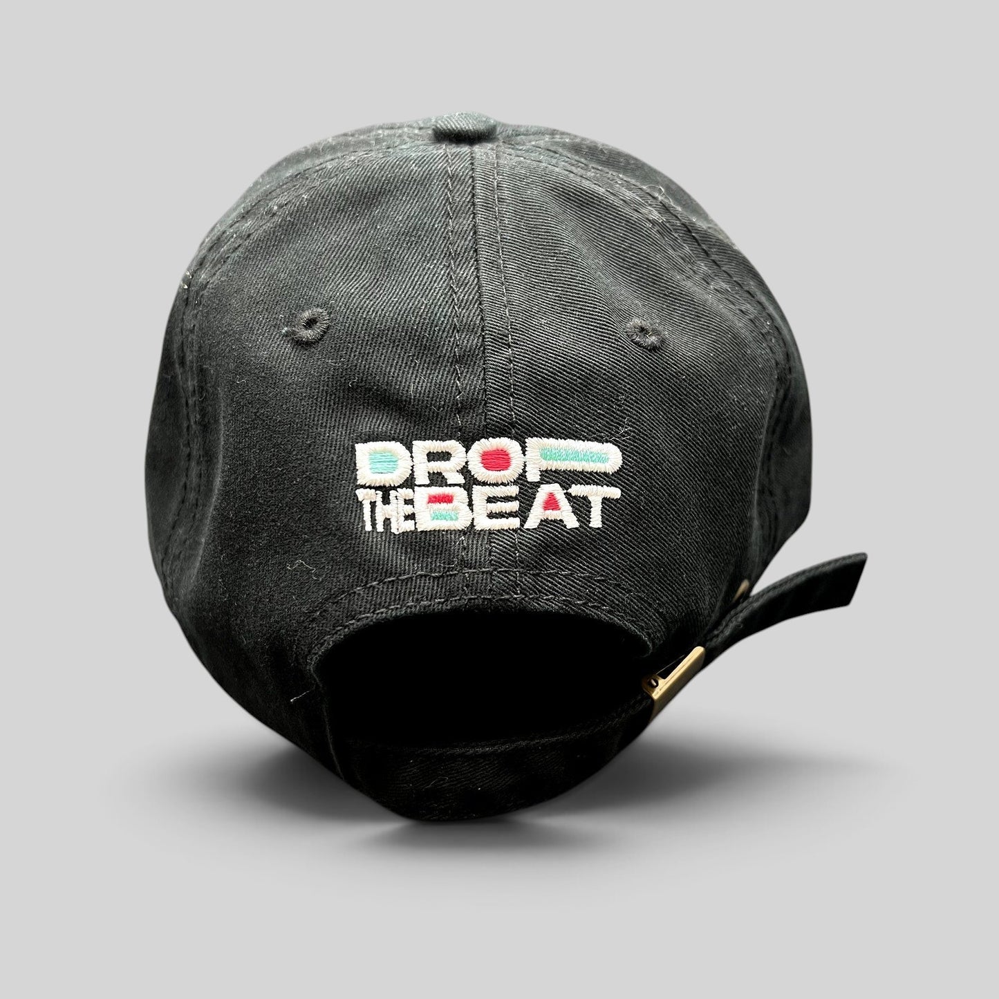 Raree Finds black TikTok strapback hat with colorful Drop The Beat embroidery on the back and brass buckle closure