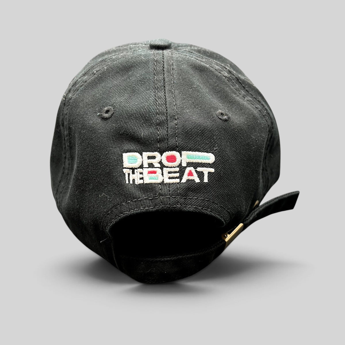 Raree Finds black TikTok strapback hat with colorful Drop The Beat embroidery on the back and brass buckle closure