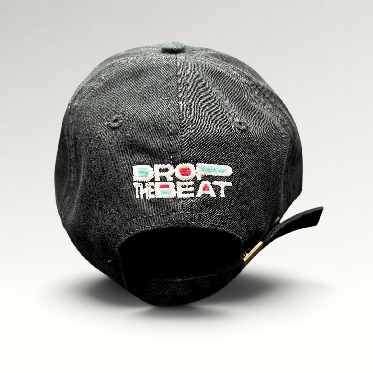 Raree Finds black TikTok strapback hat with colorful Drop The Beat embroidery on the back and brass buckle closure