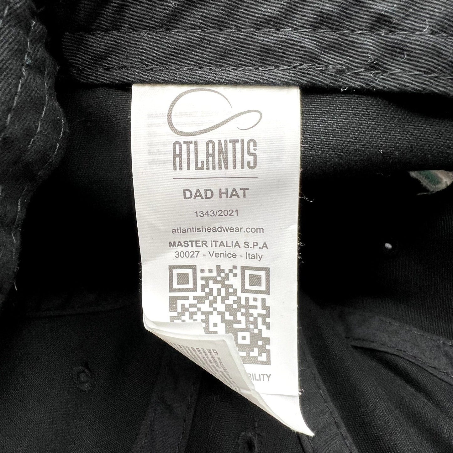 Raree Finds TikTok promotional hat interior care label by Atlantis Headwear featuring a QR code and brand details
