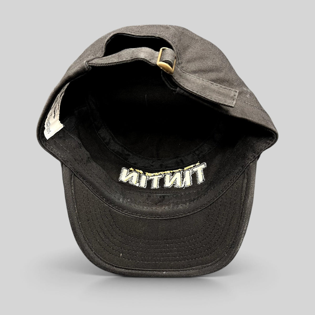 Raree Finds black 5-panel strapback hat from The Adventures of Tintin 2011 movie with brass buckle and interior tag