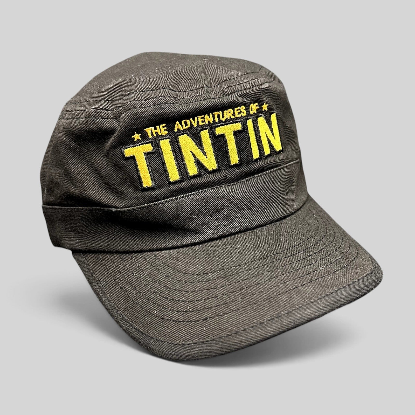 Raree Finds black 5-panel strapback hat with yellow embroidered The Adventures of Tintin movie logo