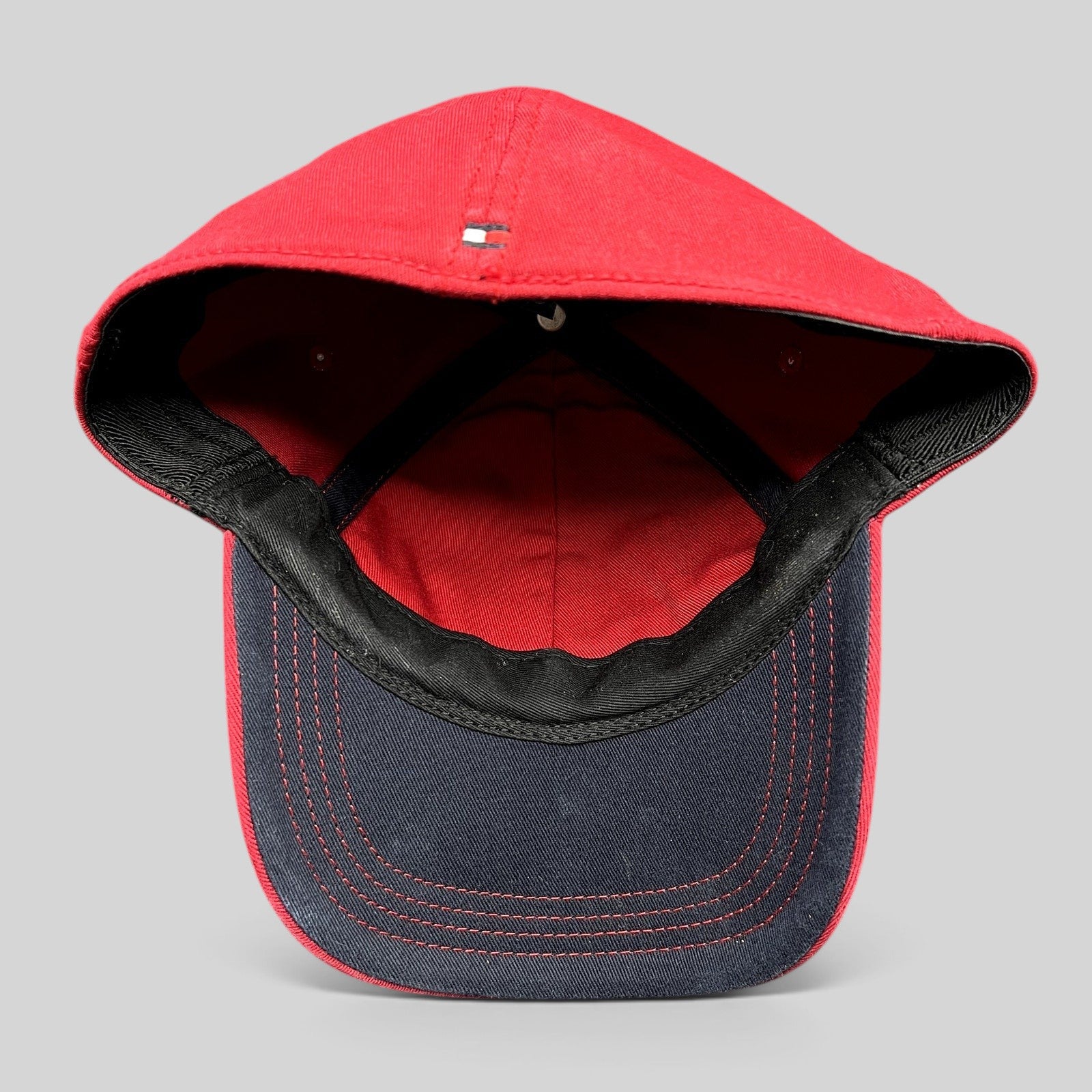 Raree Finds Tommy Hilfiger red fitted hat showing the interior construction, black sweatband, and dark undervisor.