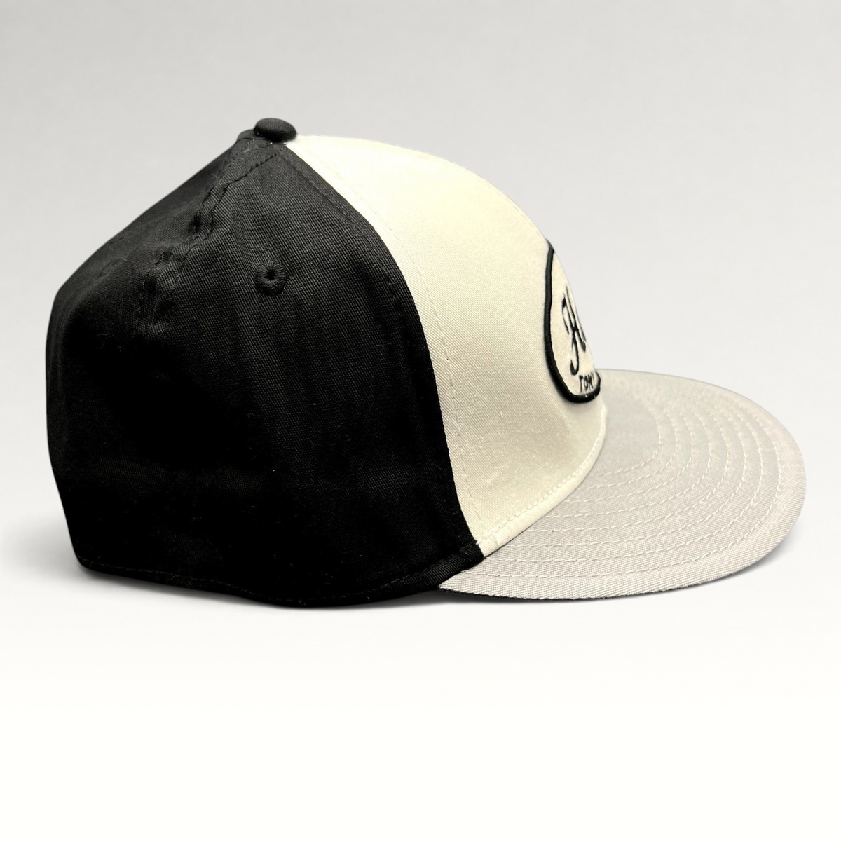 Raree Finds Tony Hawk Clothing black and white strapback hat with embroidered script logo on a curved bill