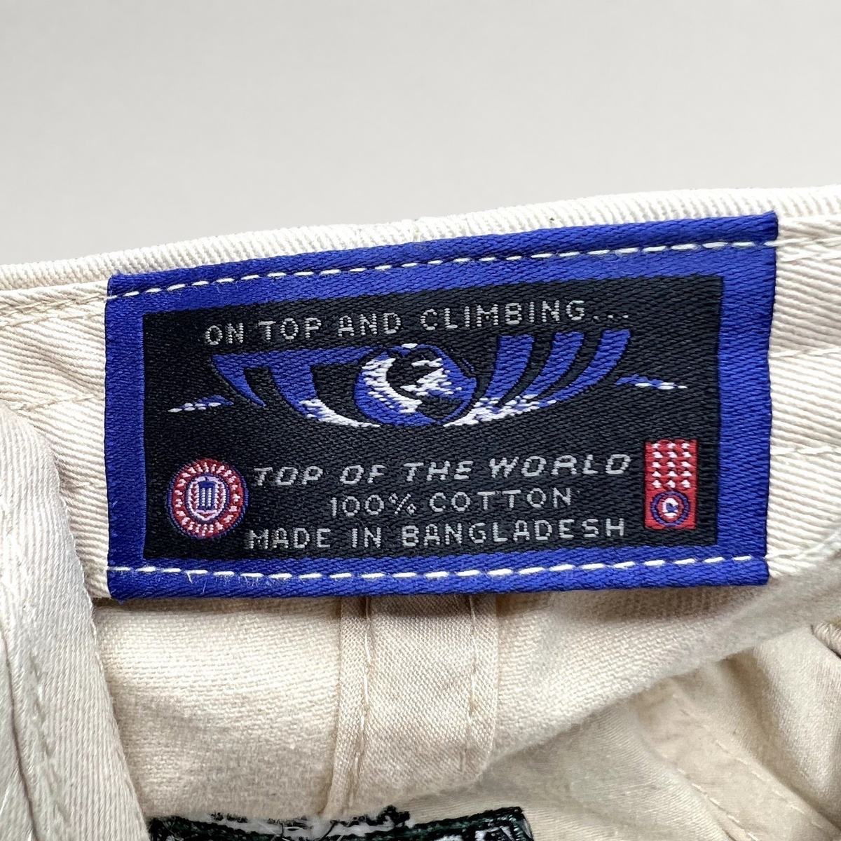 Raree Finds Top of the World cream cotton hat interior label with brand logo and manufacturing details