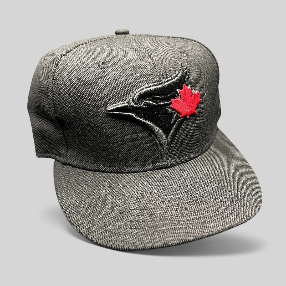 Raree Finds New Era Toronto Blue Jays snapback hat in black with a tonal logo and red maple leaf embroidery.