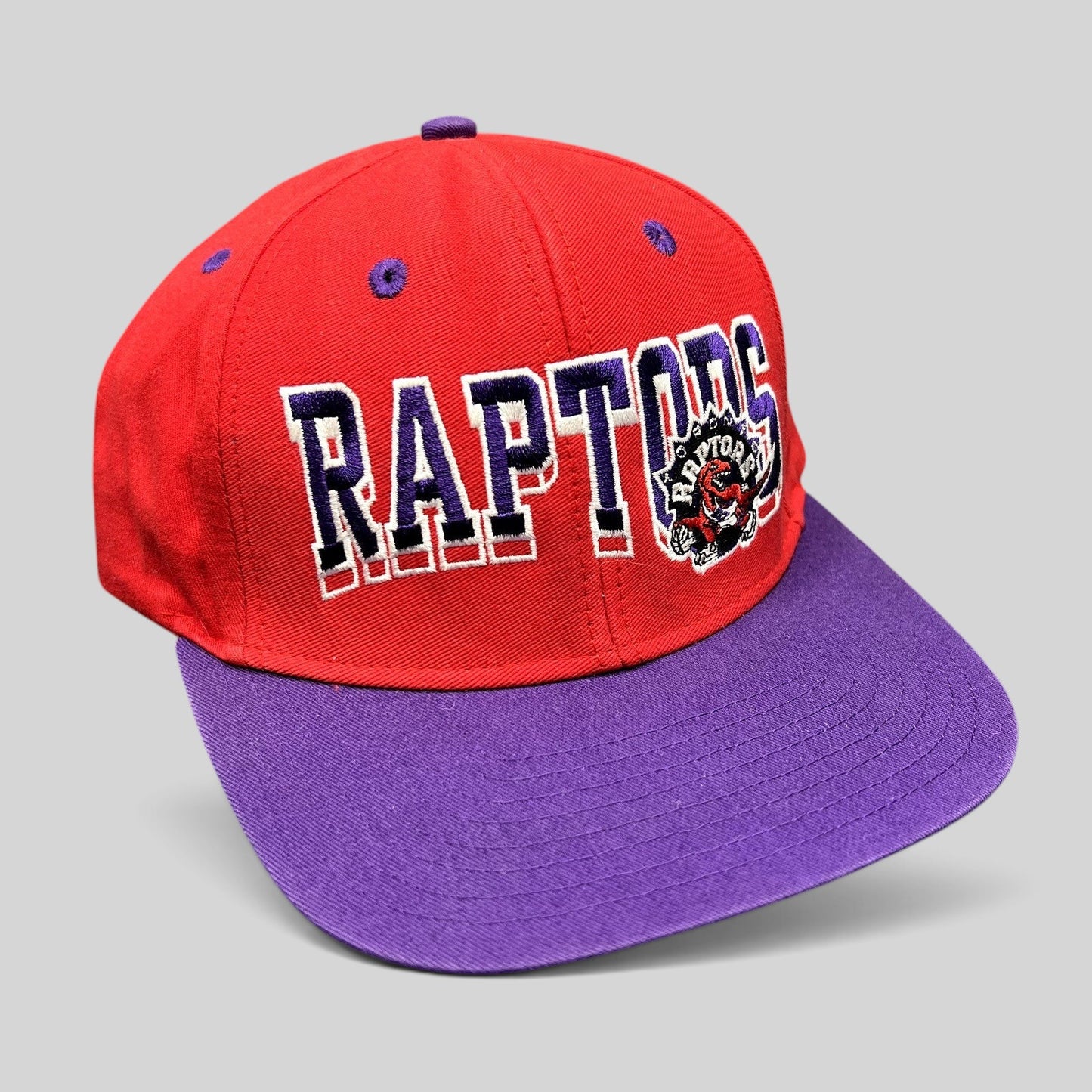 Raree Finds vintage Toronto Raptors Adidas Hardwood Classics snapback hat in red and purple with embroidered logo.
