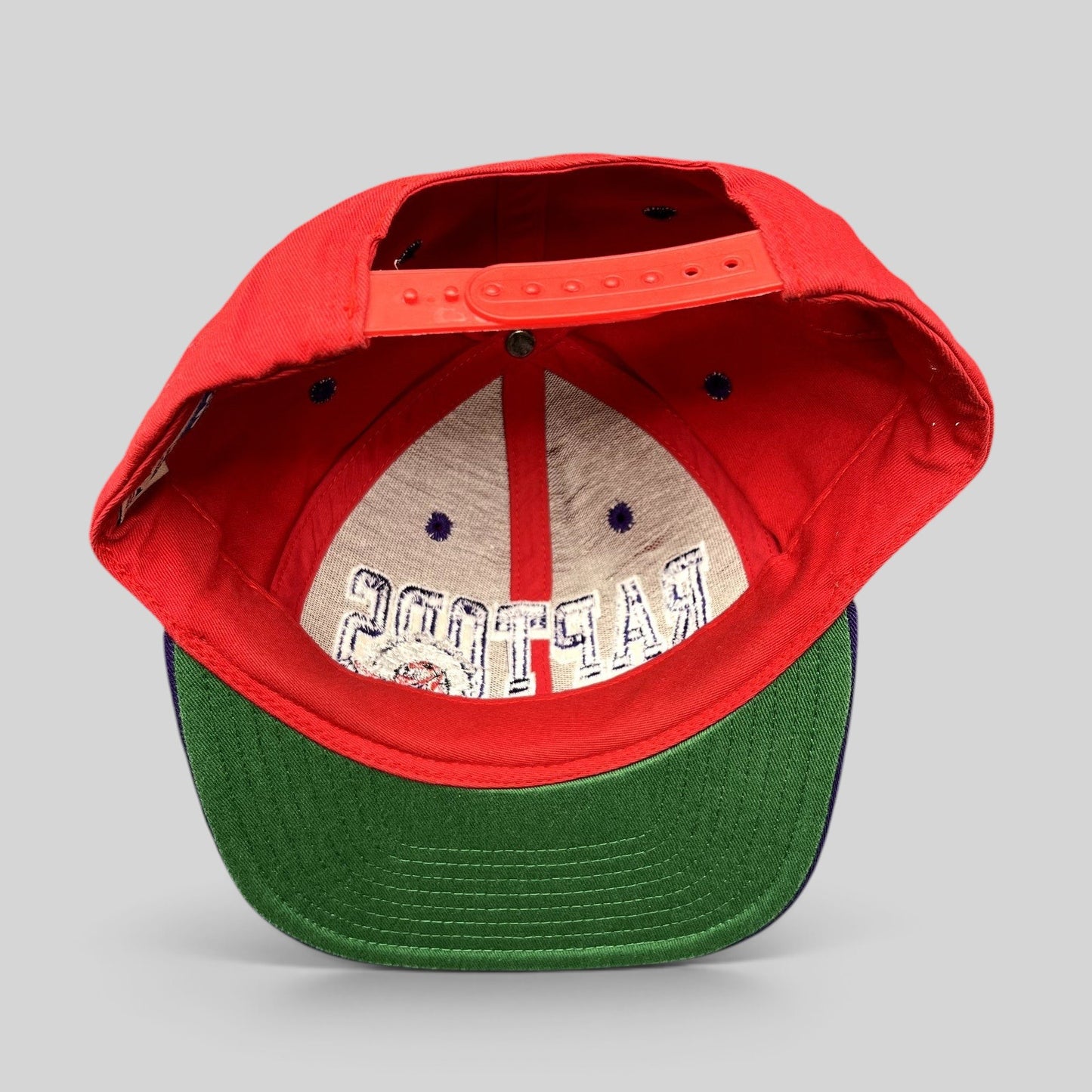 Raree Finds vintage Adidas Toronto Raptors Hardwood Classics snapback hat with red crown and green undervisor