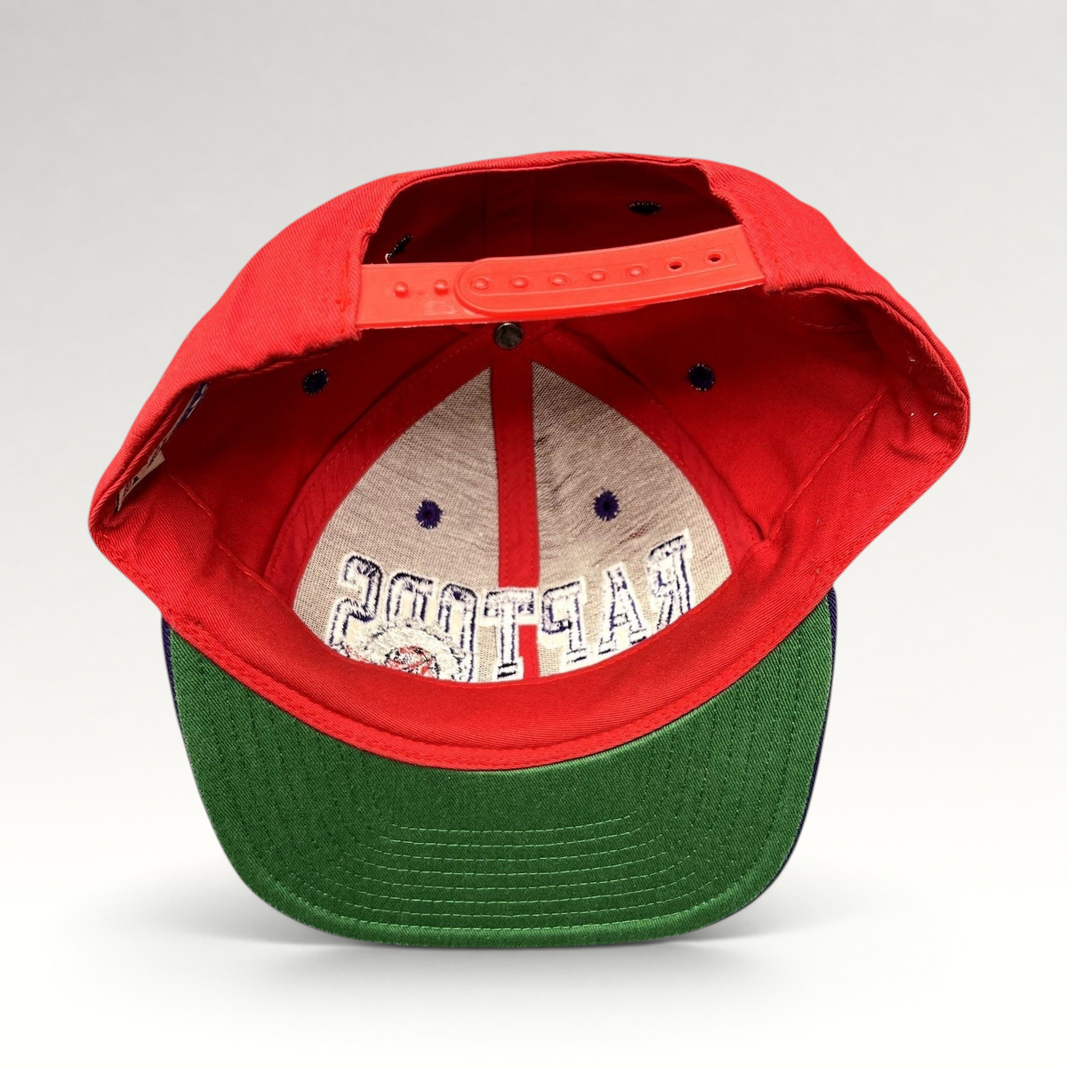Raree Finds vintage Adidas Toronto Raptors Hardwood Classics snapback hat with red crown and green undervisor