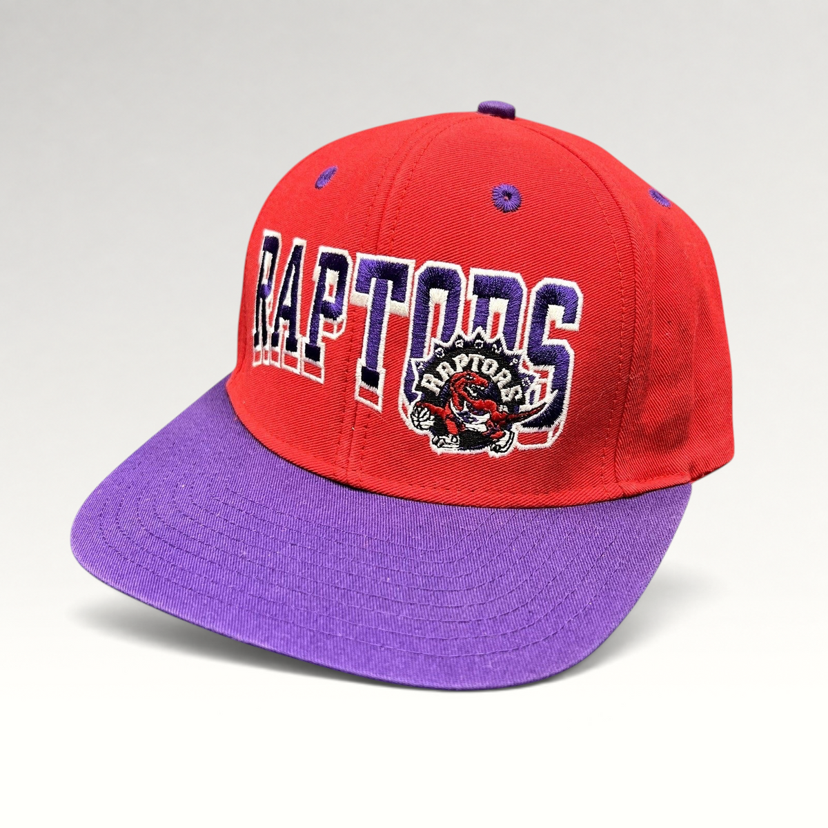Raree Finds vintage Toronto Raptors Adidas Hardwood Classics snapback hat in red and purple with embroidered logo.