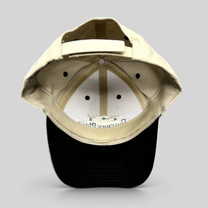 Raree Finds Tourney Place dad hat showing the interior khaki crown, black brim, and adjustable strapback closure.