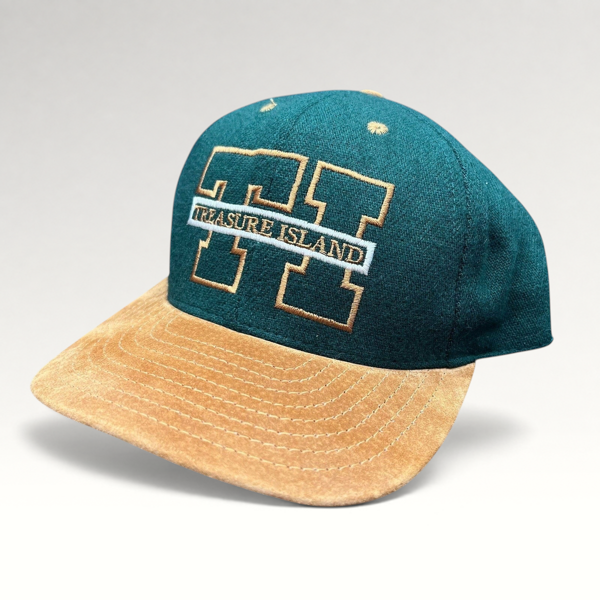 Raree Finds vintage Treasure Island Las Vegas snapback hat with a green wool crown and tan suede brim.