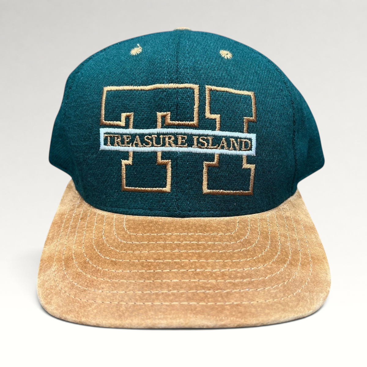 Raree Finds vintage Treasure Island Las Vegas snapback hat with a green wool crown and tan suede brim.