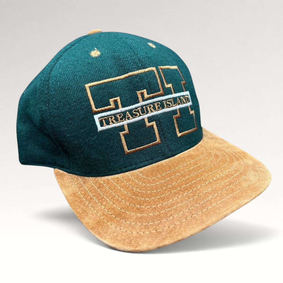 Raree Finds vintage Treasure Island Las Vegas snapback hat with a green wool crown and tan suede brim.