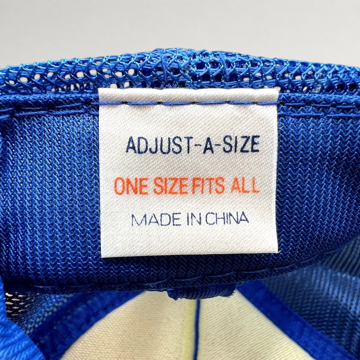 Raree Finds vintage trucker hat interior label showing Adjust-A-Size one size fits all and Made in China text