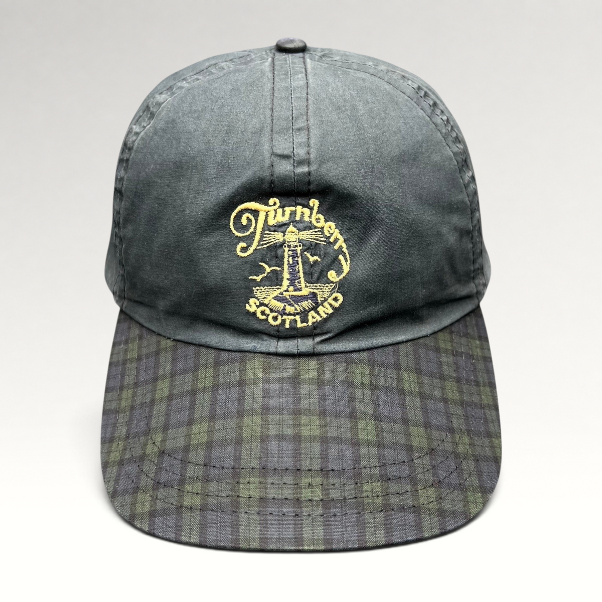 Raree Finds vintage Turnberry Scotland golf hat in dark navy with an embroidered lighthouse logo and tartan plaid bill.