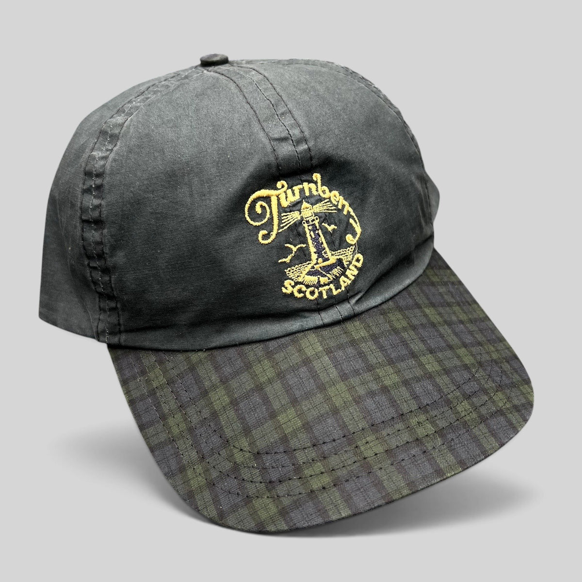 Raree Finds vintage Turnberry Scotland golf hat in navy with a Black Watch tartan plaid bill and lighthouse embroidery.