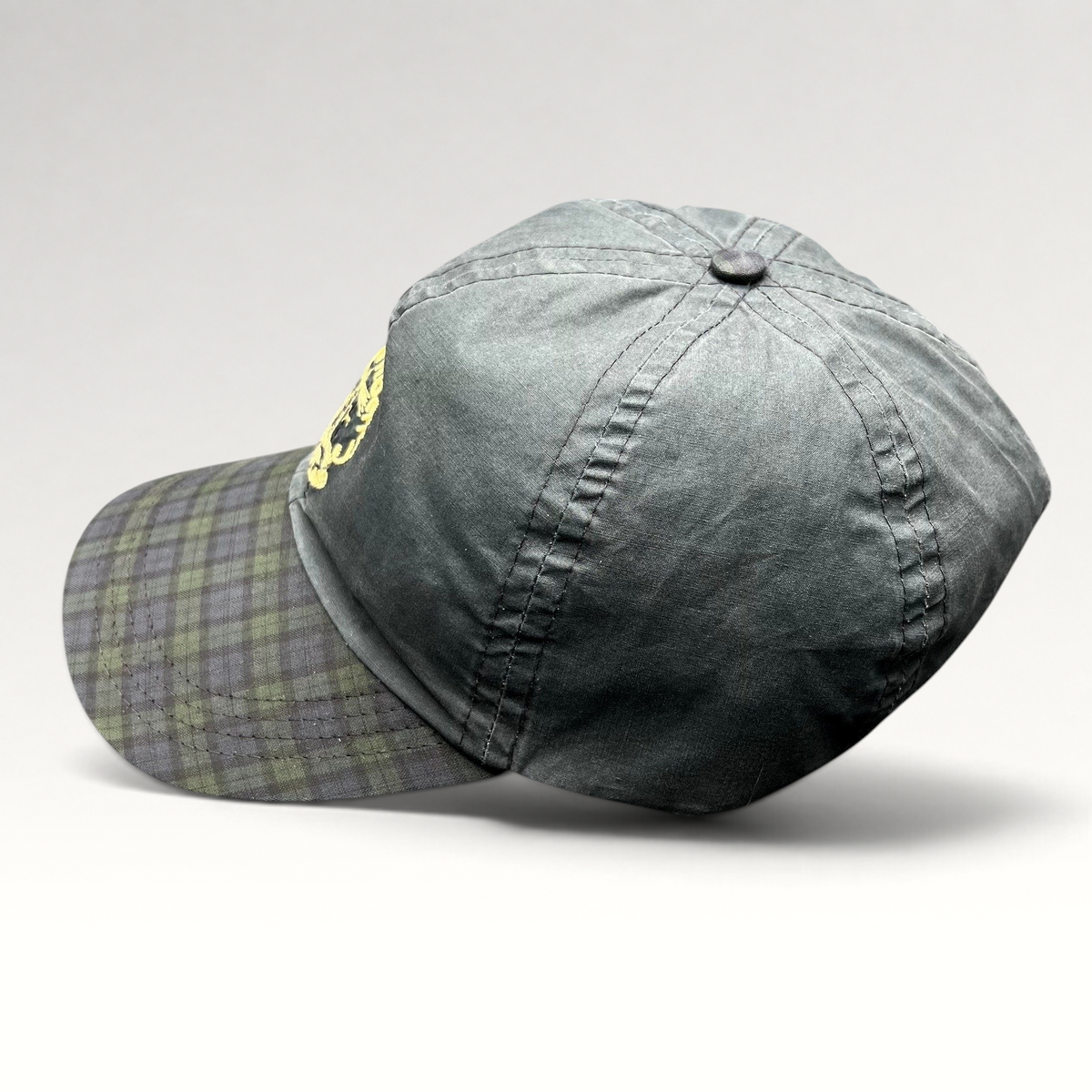 Raree Finds vintage Turnberry Scotland golf hat in dark navy with a Black Watch tartan plaid bill and lighthouse logo.