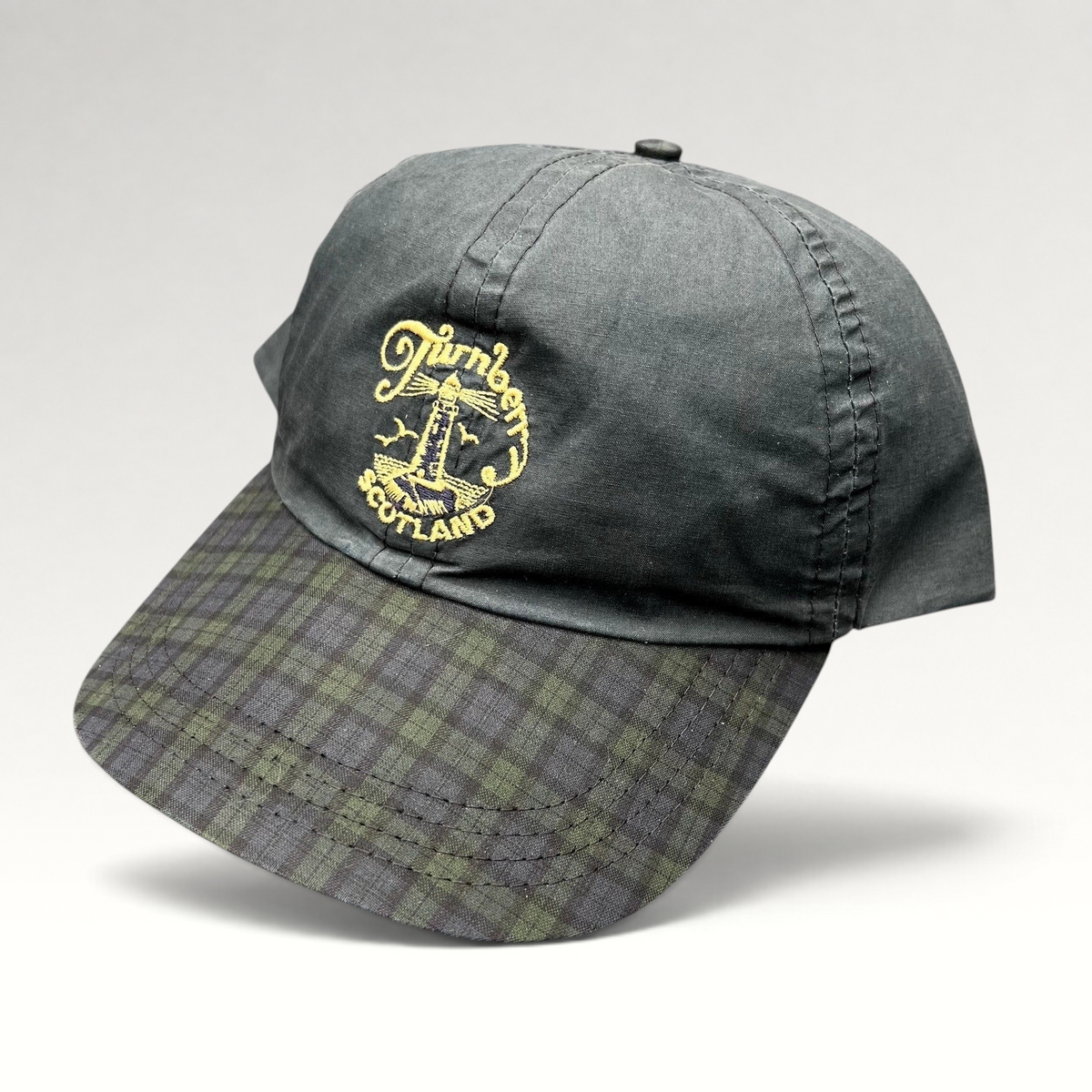 Raree Finds vintage Turnberry Scotland golf hat in dark navy with an embroidered lighthouse logo and tartan plaid bill.