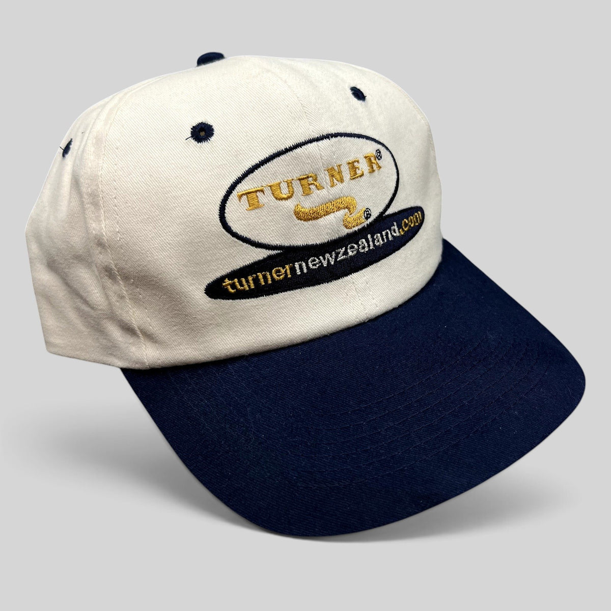 Raree Finds vintage Turner New Zealand snapback hat with white crown, navy brim, and embroidered agricultural logo.