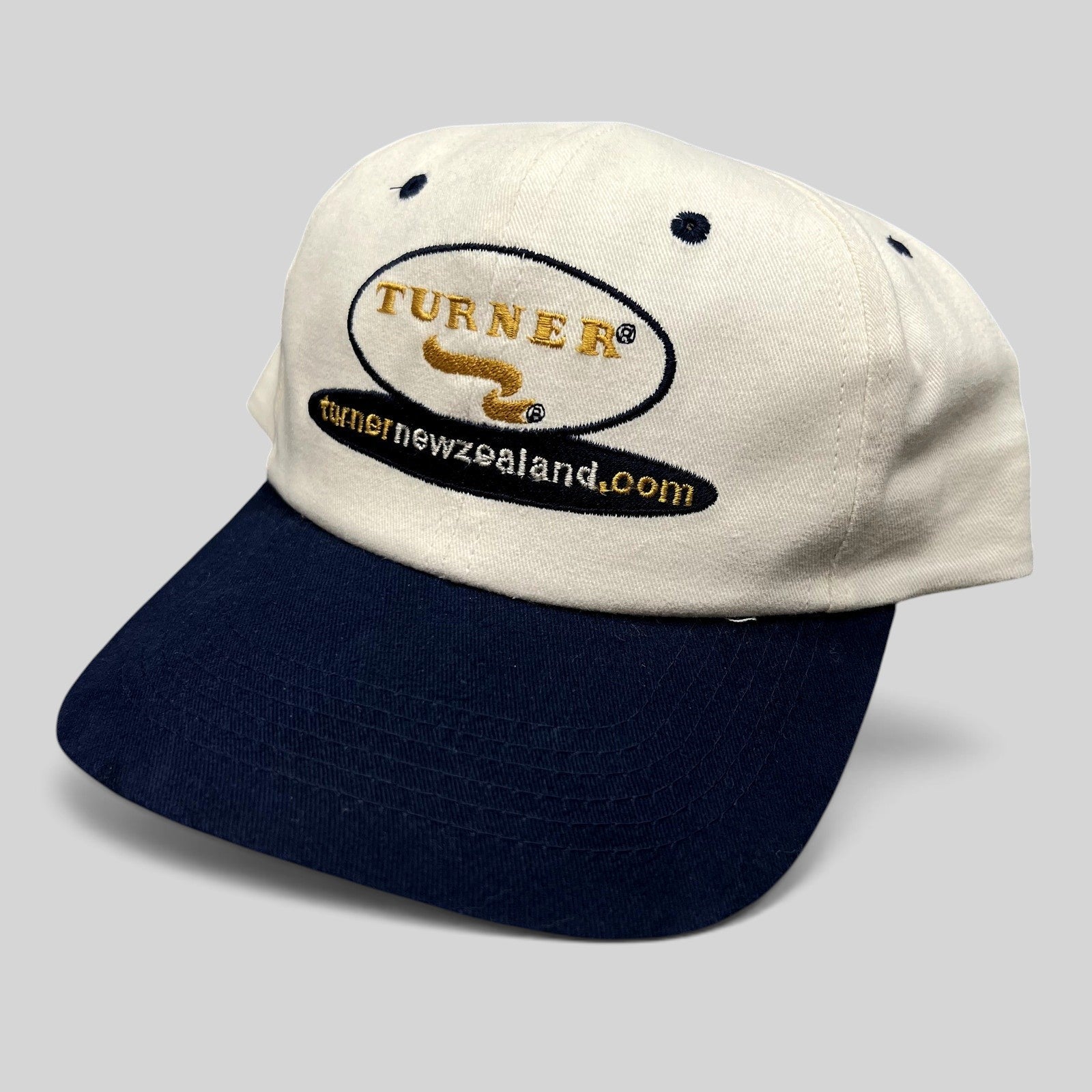 Raree Finds vintage Turner New Zealand cotton snapback hat with white crown, navy brim, and embroidered logo.