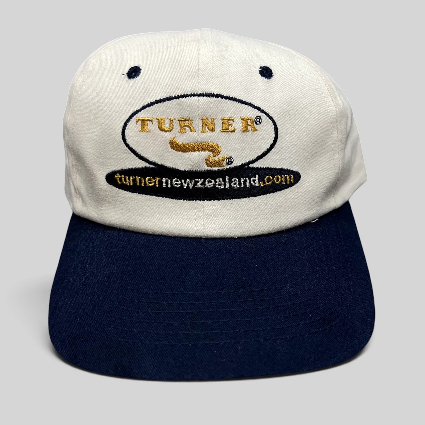 Raree Finds vintage Turner New Zealand snapback hat with white cotton crown, navy brim, and embroidered logo.