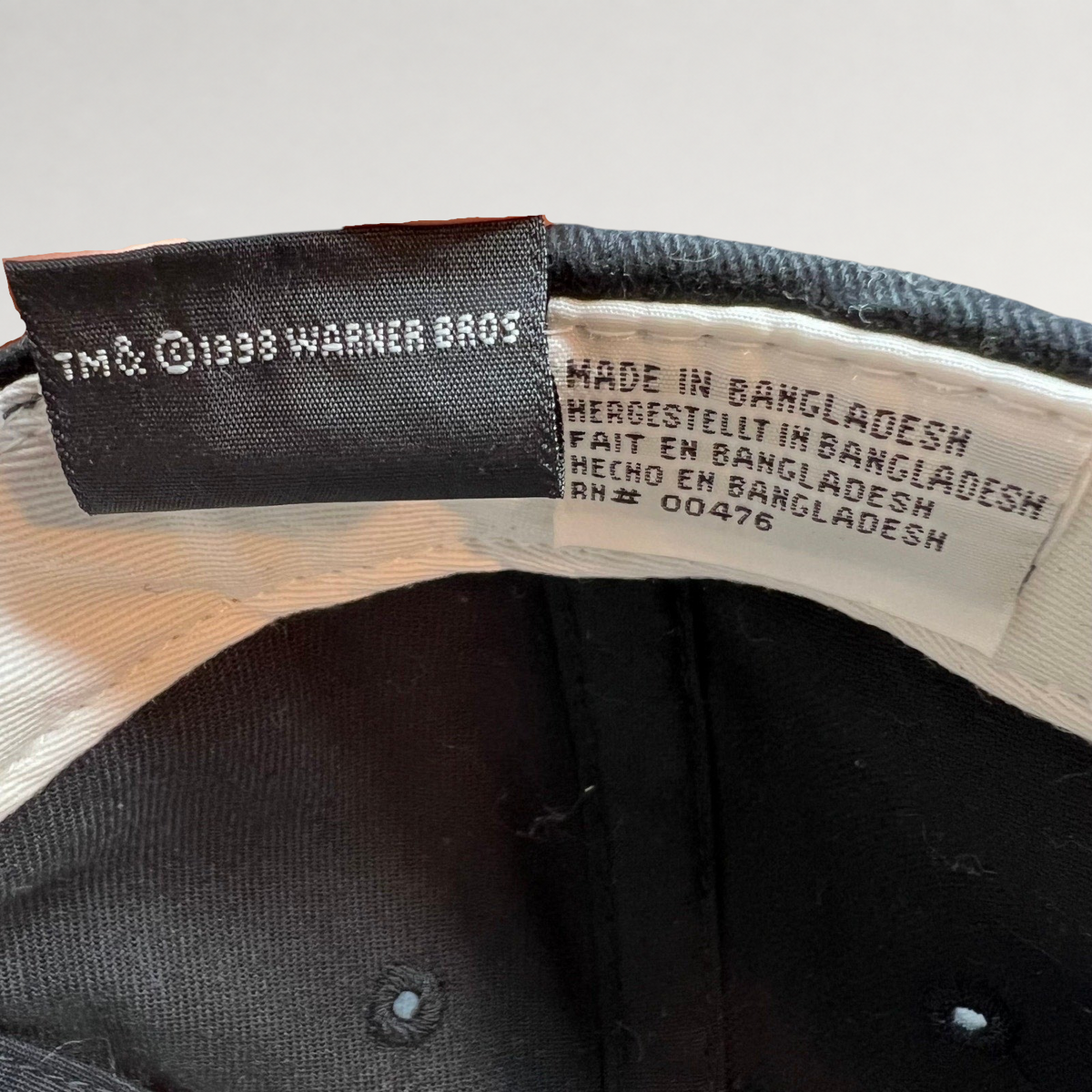 Raree Finds vintage 1998 Warner Bros Tweety Bird hat interior tag showing manufacturing details and copyright