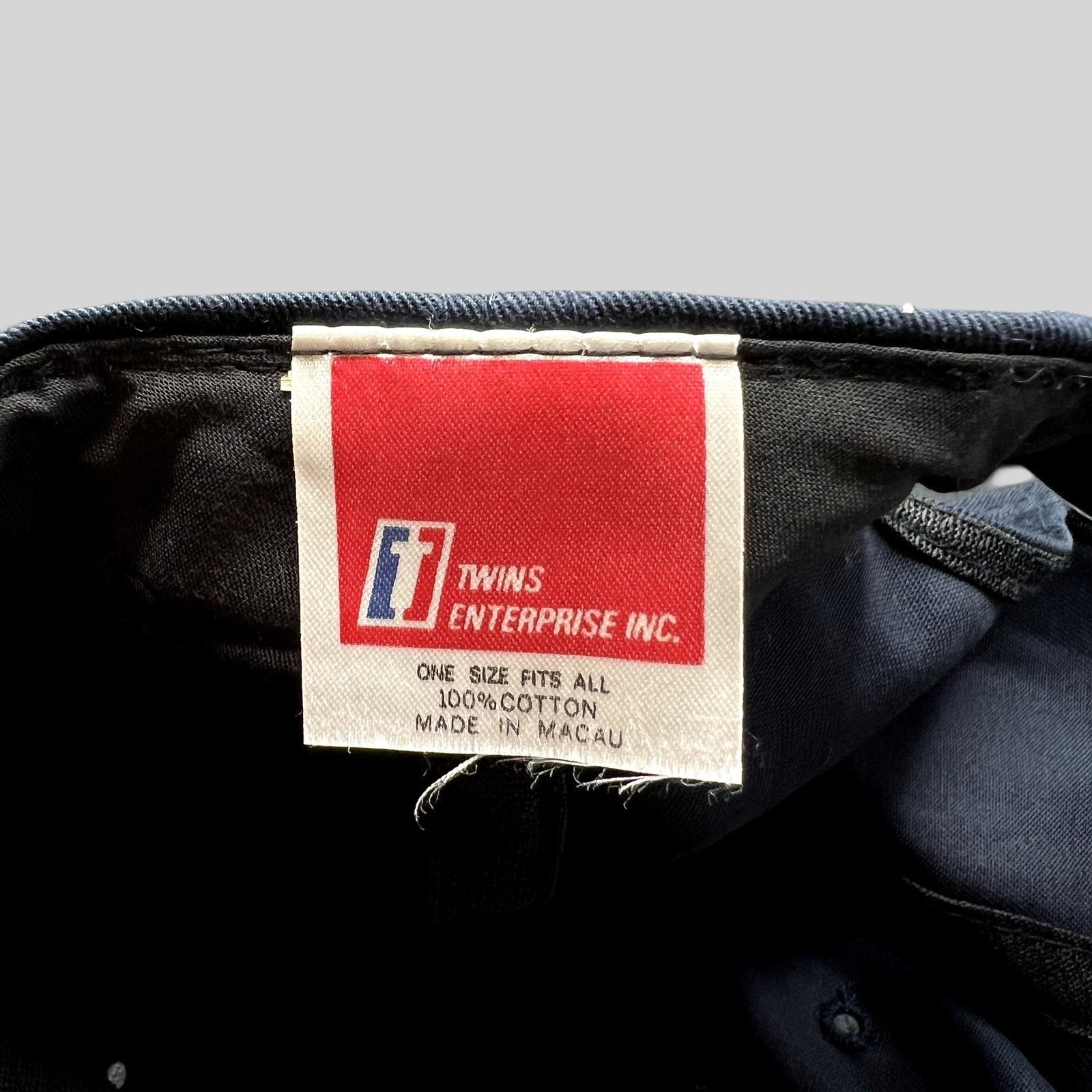 Raree Finds vintage Twins Enterprise snapback hat interior tag showing brand logo and material details