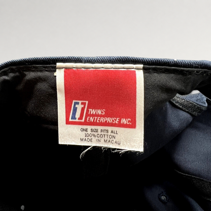 Raree Finds vintage Twins Enterprise tag inside a navy blue Michigan Wolverines snapback hat made of 100% cotton.