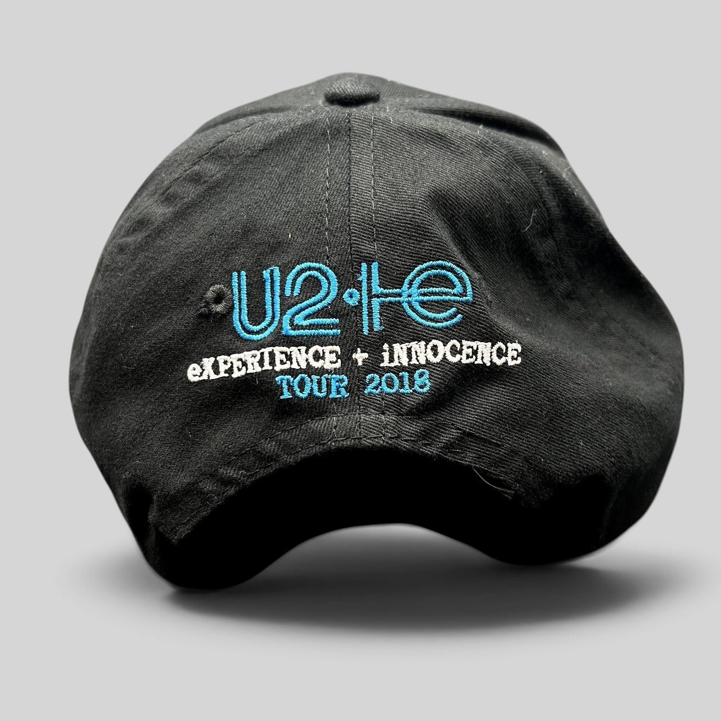 Raree Finds black U2 eXPERIENCE + iNNOCENCE Tour 2018 strapback hat with blue and white embroidered rear logo