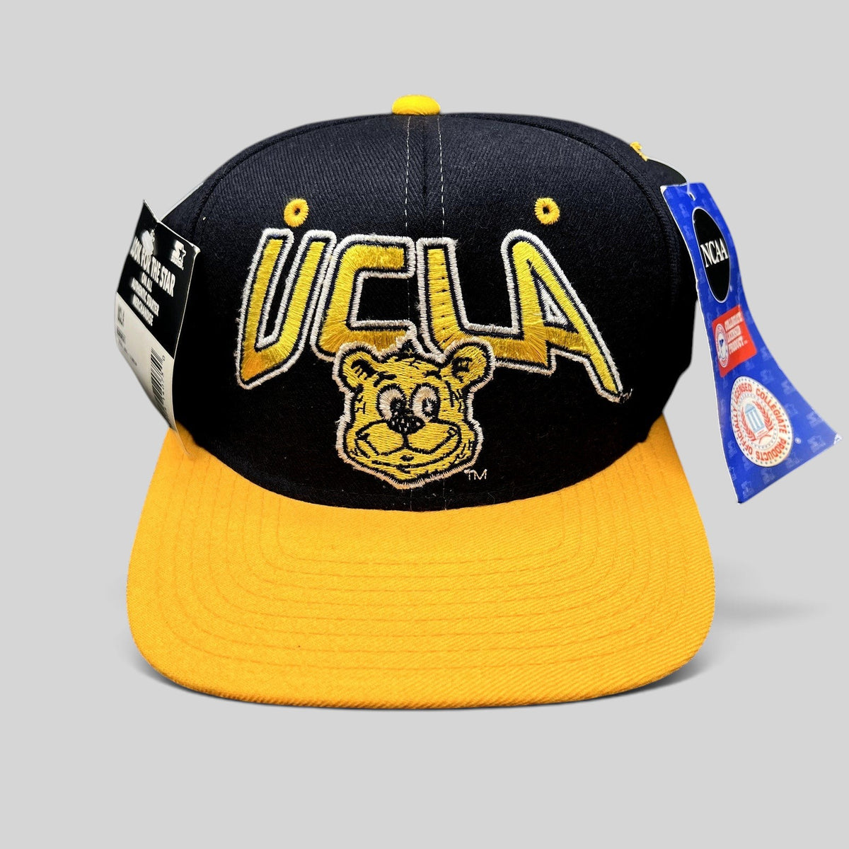 Raree Finds vintage UCLA Bruins wool snapback hat in navy and gold with embroidered bear mascot and Starter tags.