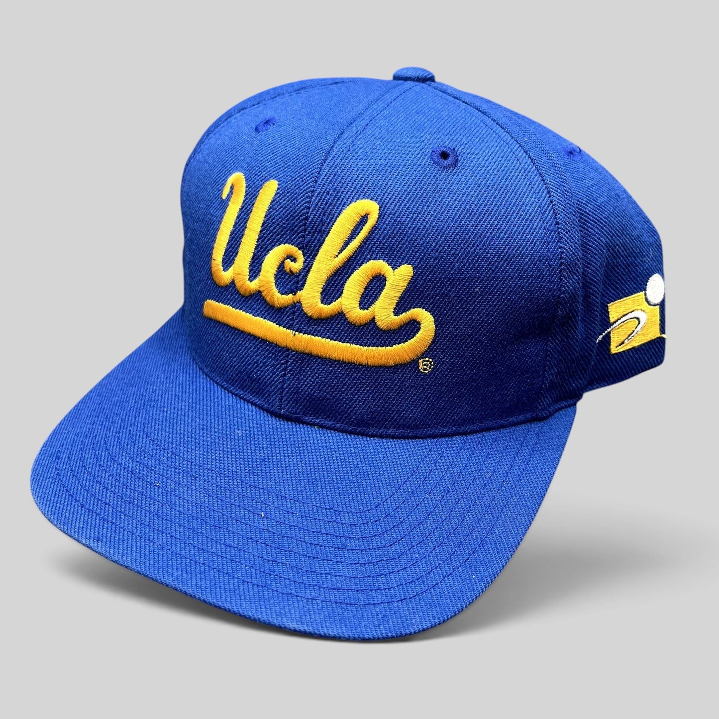 Raree Finds vintage UCLA Bruins royal blue snapback hat with gold script embroidery and green undervisor