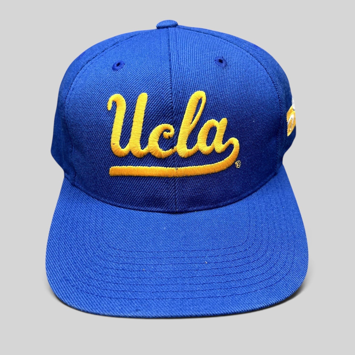Raree Finds vintage UCLA Bruins royal blue snapback hat with gold script embroidery and structured six-panel design.
