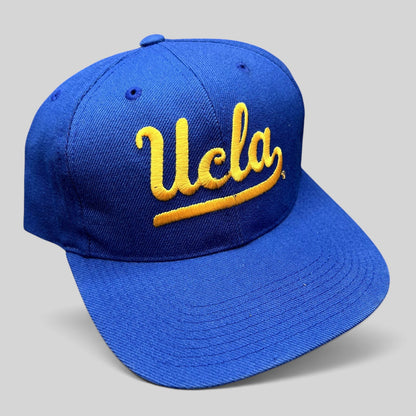 Raree Finds vintage UCLA Bruins royal blue snapback hat with gold script embroidery and a classic green undervisor.