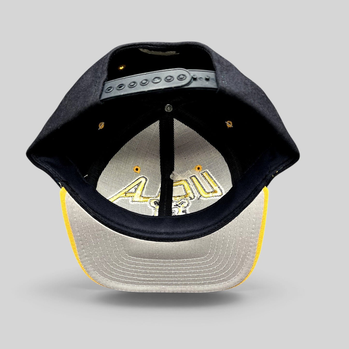 Raree Finds vintage UCLA Bruins Starter snapback hat showing the interior crown, adjustable strap, and gold brim
