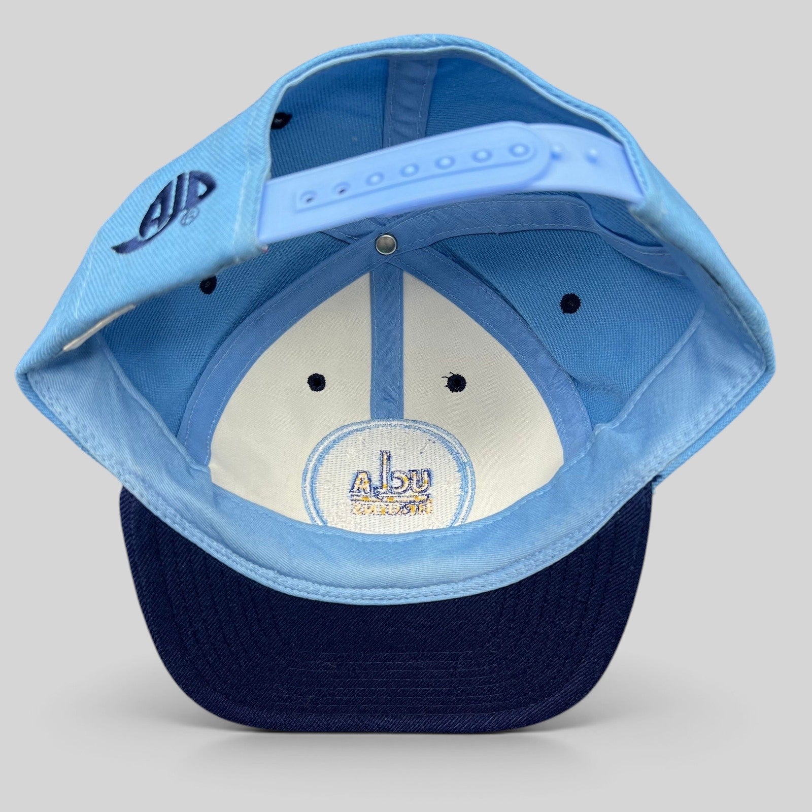 Raree Finds vintage AJD UCLA Bruins snapback hat interior view showing the adjustable strap and embroidered logo