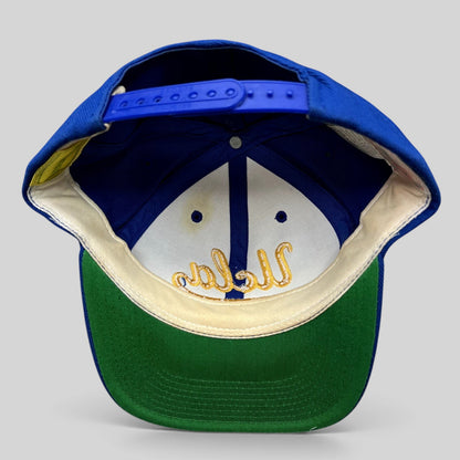 Raree Finds vintage UCLA Bruins snapback hat interior showing blue crown, gold script embroidery, and green undervisor