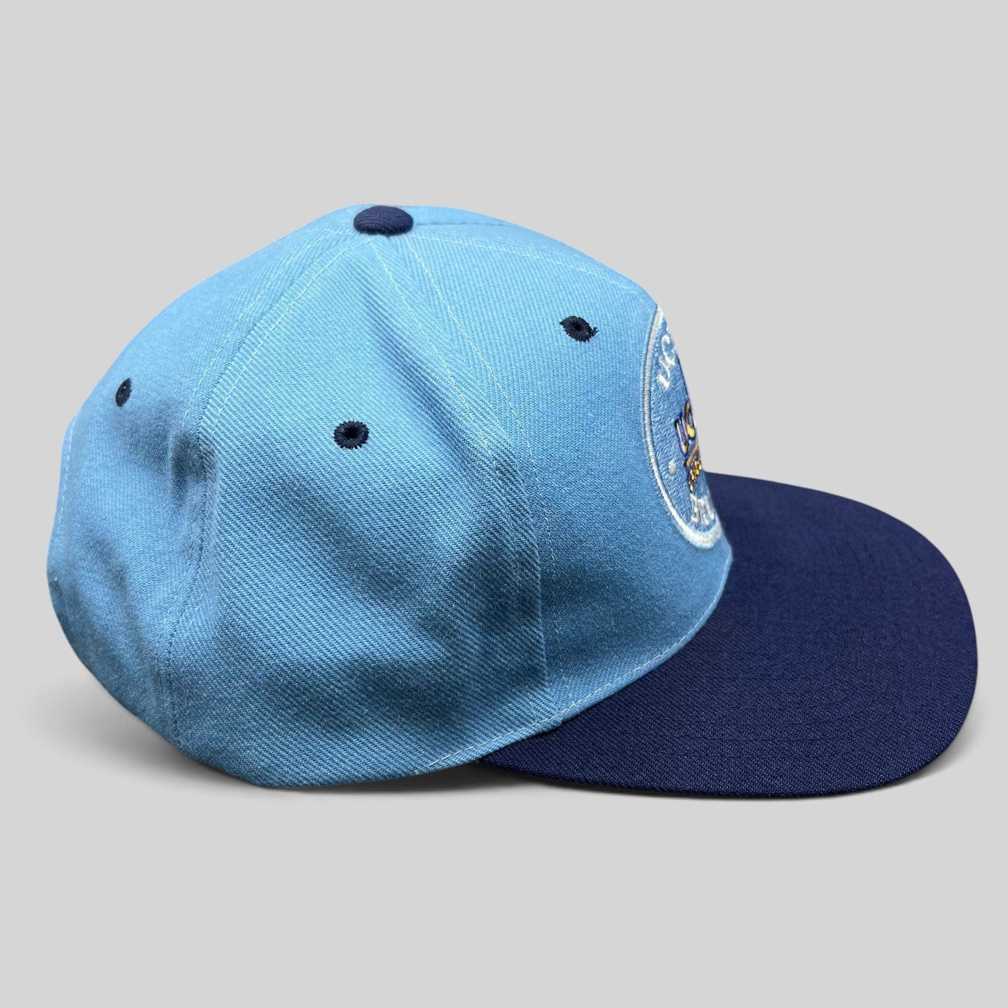 Raree Finds vintage AJD UCLA Bruins snapback hat in light blue and navy with a circular embroidered team logo