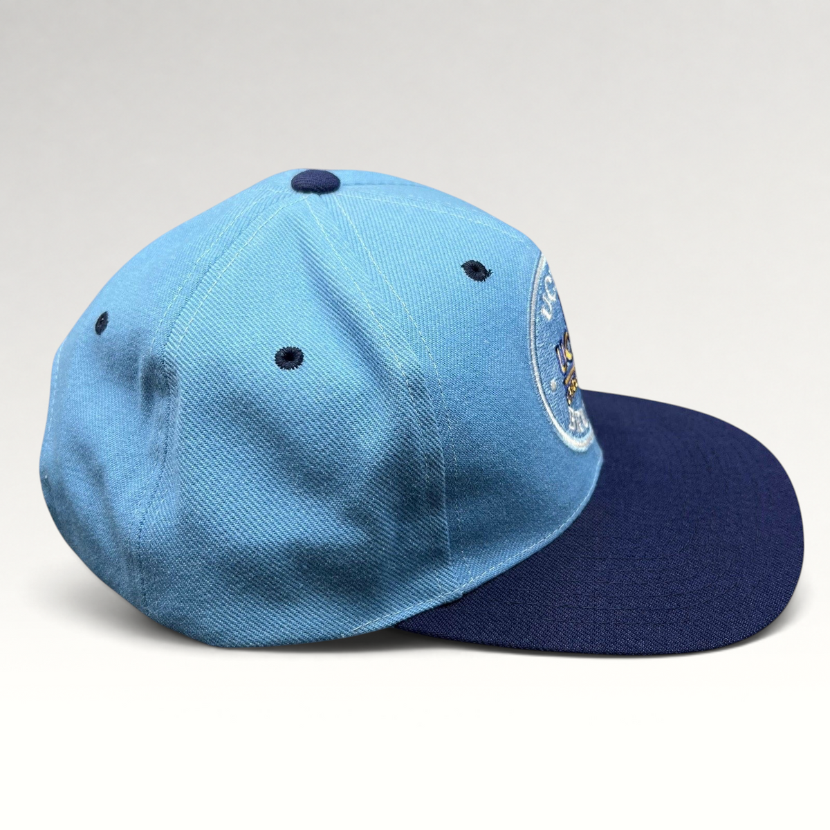 Raree Finds vintage AJD UCLA Bruins snapback hat in light blue and navy with a circular embroidered team logo