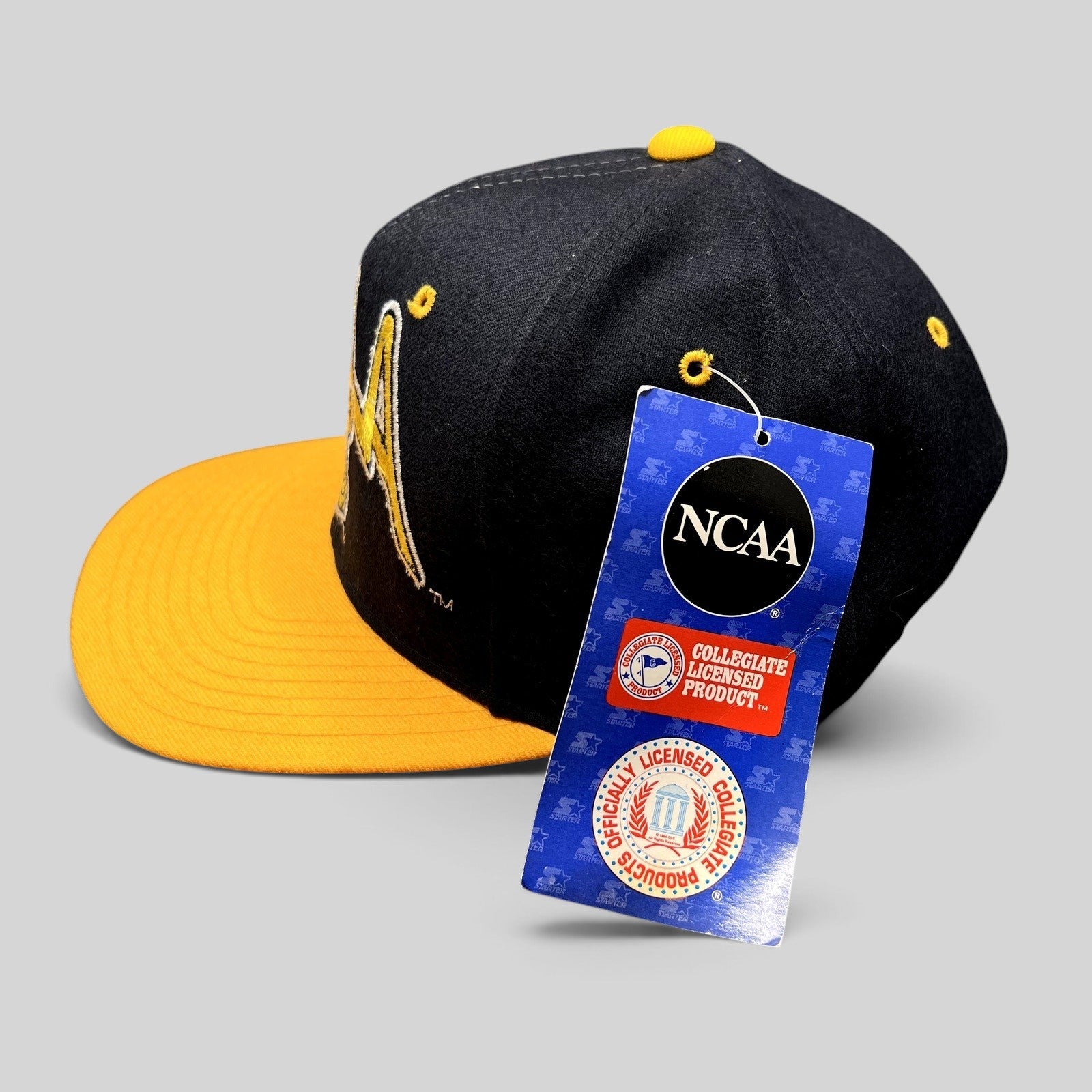 Raree Finds vintage UCLA Bruins Starter snapback hat in navy and gold wool with original NCAA tags attached