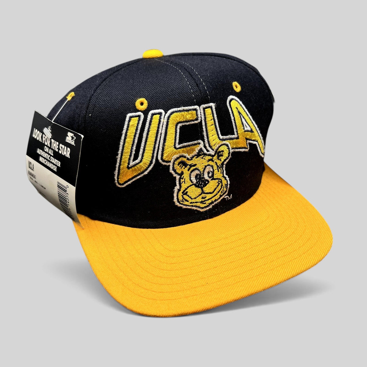 Raree Finds vintage UCLA Bruins wool snapback hat in navy and gold with embroidered bear mascot and Starter tag.