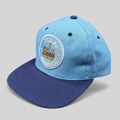 Raree Finds vintage 90s AJD UCLA Bruins snapback hat with light blue crown and navy brim featuring circular logo