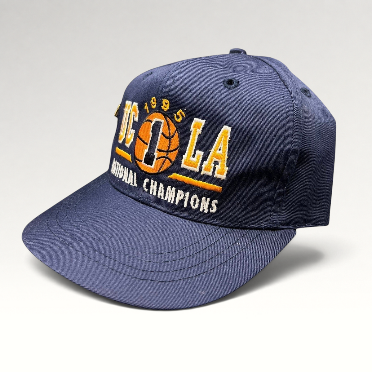 Raree Finds vintage 1995 UCLA Bruins National Champions navy blue snapback hat with embroidered basketball graphic