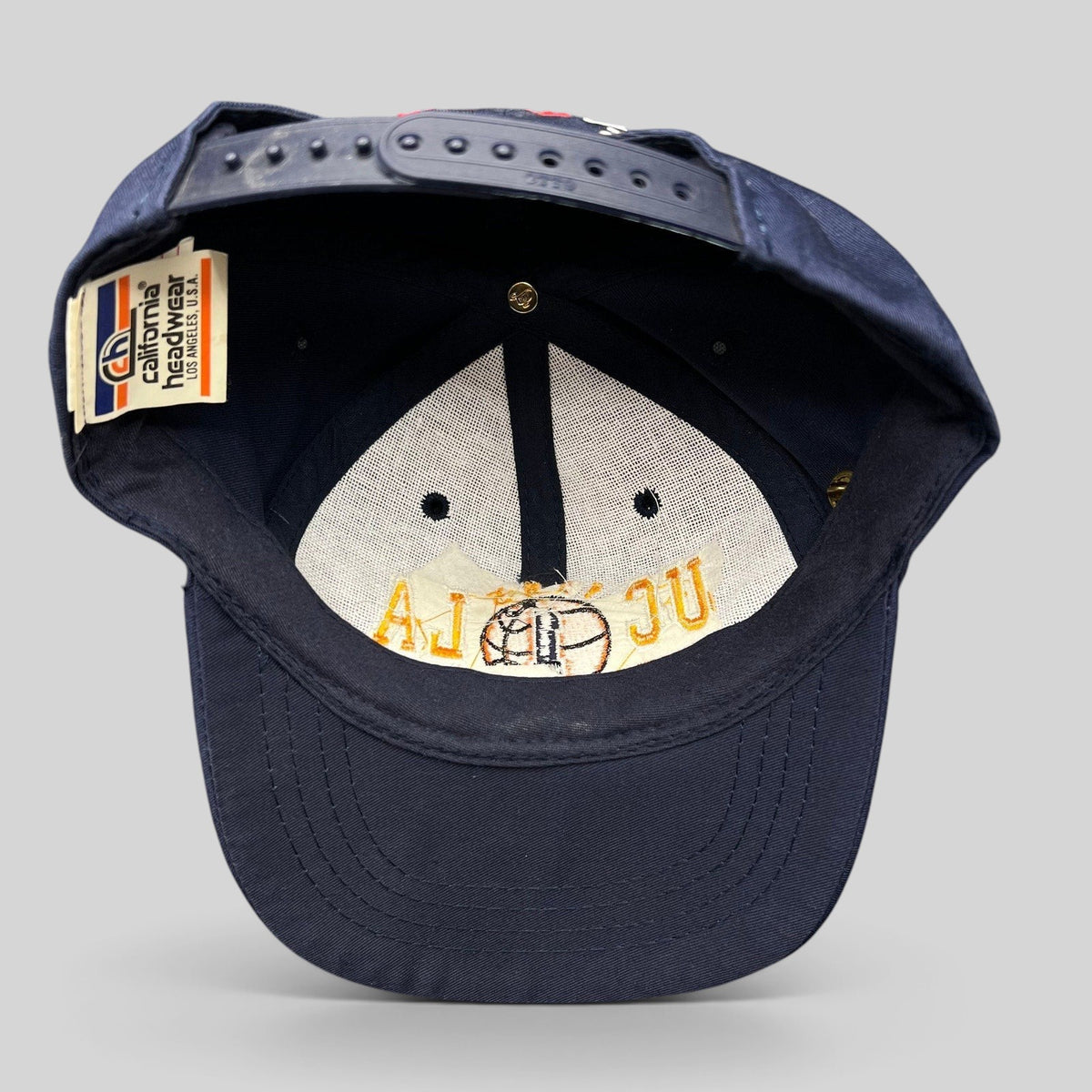 Raree Finds vintage 1995 UCLA National Champions snapback hat interior showing California Headwear tag and embroidery