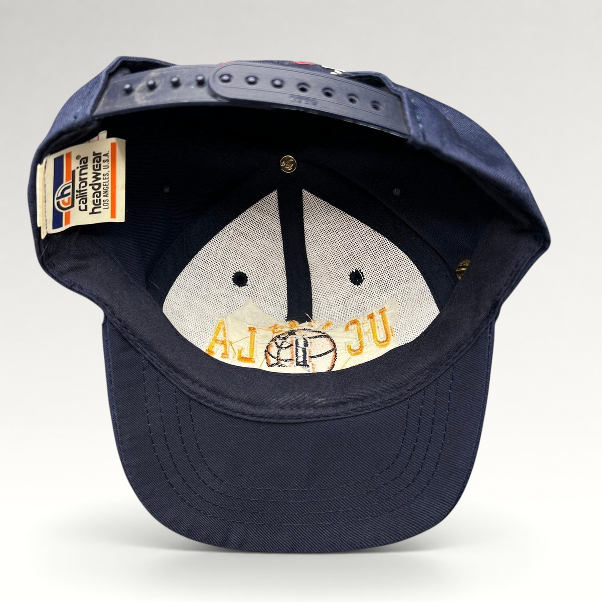Raree Finds vintage 1995 UCLA National Champions snapback hat interior showing California Headwear tag and embroidery